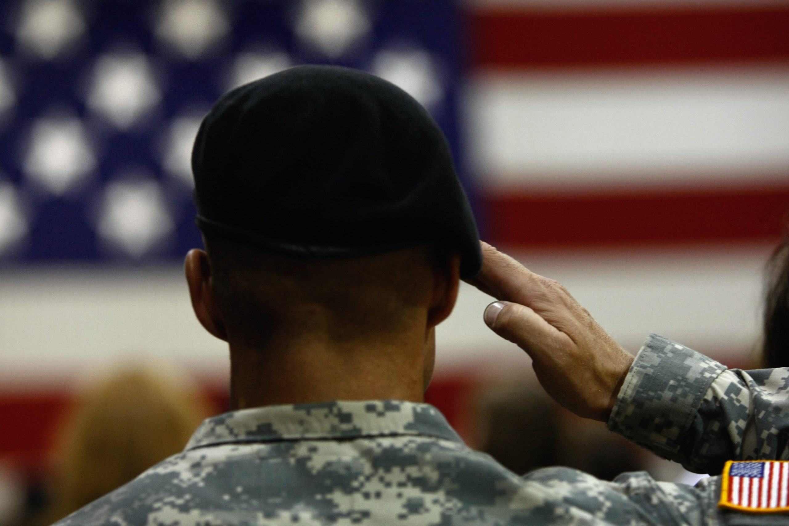 Army soldier salutes during the national anthem